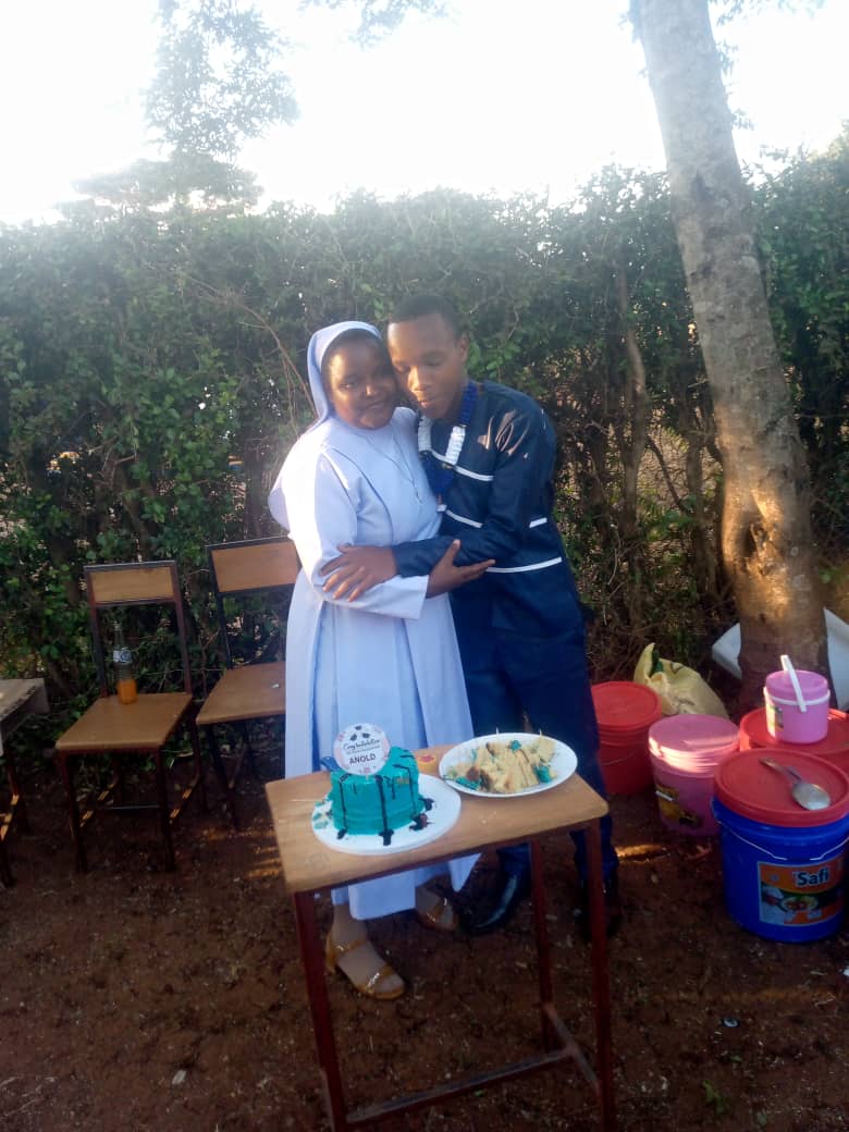 Photo of Anold with principal Sister Sindano